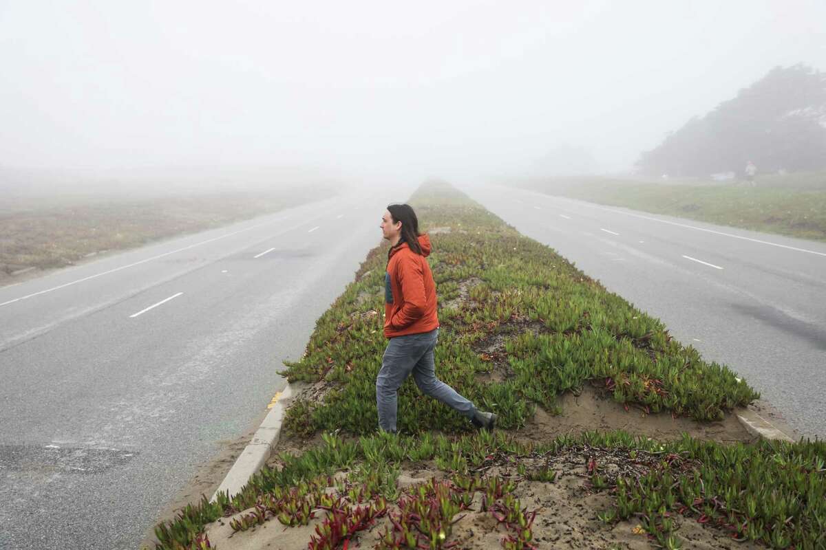 Michael Flagg, an air quality scientist at the Bay Area Air Quality Management District, crosses the Great Highway as he makes his way to Ocean Beach in San Francsico this past March. Flagg goes to the beach daily.