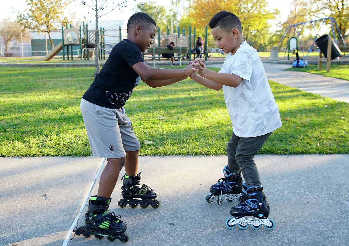 Friends Arthur Regis, 8, left, and Jonathon Serbin, 7, spin around on their in-line skates on Monday, Nov. 28, 2022 in Houston. The second and third grader enjoyed their day off, but Arthur’s mom, Shay Holmes was surprised. Holmes has three children in school and one in day care, all were cancelled because of the water boil mandate. “I went to bed at 8pm, woke up at 4 am to get ready for work and the kids ready for school, and found out then it was cancelled.” She was able to take the day off from work, and was thankful she had more of a notice about Tuesday’s cancellation.