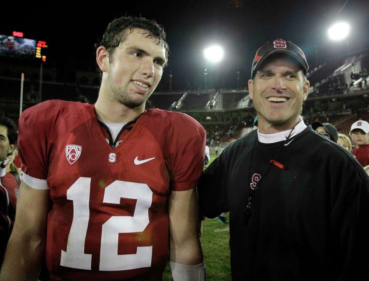 In this Nov. 6, 2010, photo, Stanford coach Jim Harbaugh and quarterback Andrew Luck (12) stand on the field after an NCAA college football game against Arizona in Stanford, Calif. Luck has decided to stay in college to get his degree instead of immediately cashing in on the riches of being the likely No. 1 pick in the NFL draft. He announced his decision Thursday, Jan. 6, 2011. (AP Photo/Paul Sakuma)