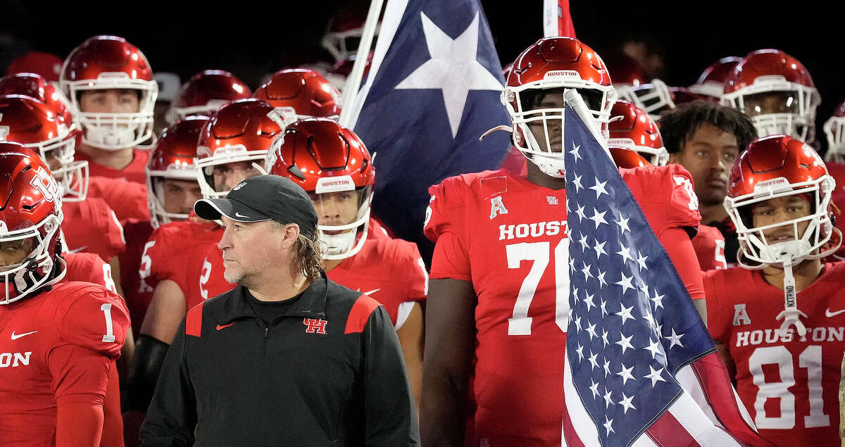 Houston Cougars head coach Dana Holgorsen stands in front of the team as they prepared to take the field before the start of the first half of an NCAA football game at TDECU Stadium on Saturday, Nov. 26, 2022 in Houston .