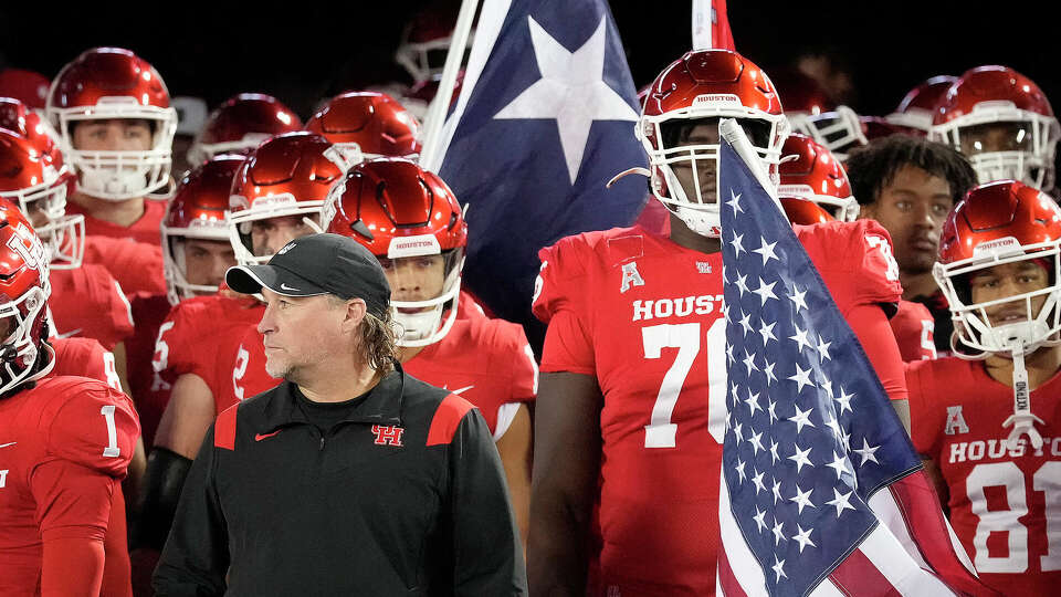 Houston Cougars head coach Dana Holgorsen stands in front of the team as they prepared to take the field before the start of the first half of an NCAA football game at TDECU Stadium on Saturday, Nov. 26, 2022 in Houston .