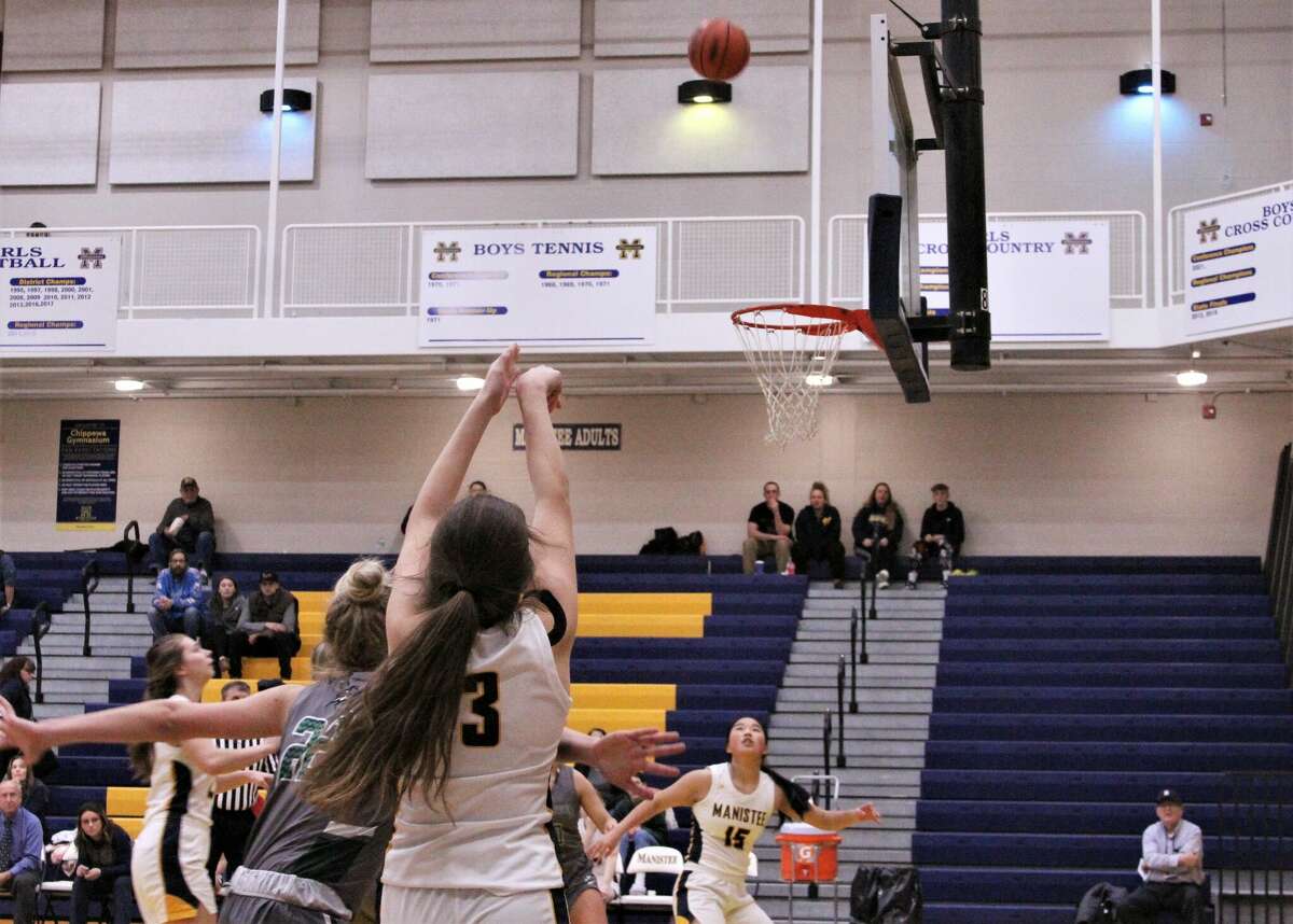 Manistee junior Libby McCarthy watches her shot soar through the air against LeRoy Pine River on Nov. 28 at Manistee High School. 