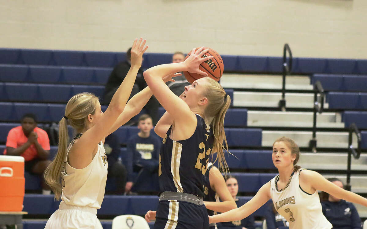 Father McGivney's Sami Oller attempts a contested layup against Maryville Christian on Monday. Oller finished with a career-high 23 points in the conference win. 