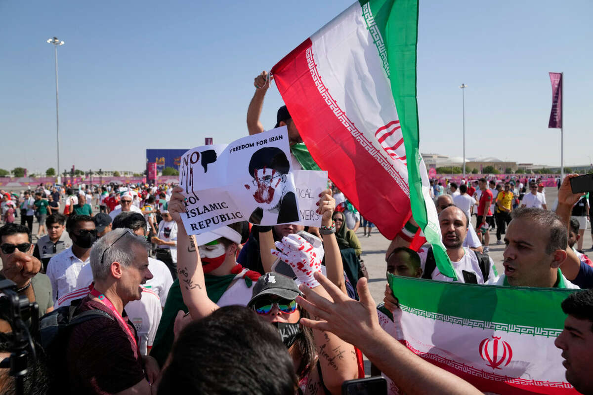 Protesters and supporters of the Iranian soccer team clash at a World Cup match in Qatar on Friday, Nov. 25. 