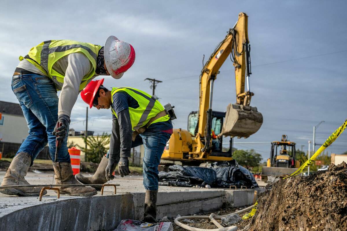 Construction workers work on repairing an intersection on November 22, 2022 in Houston, Texas. 