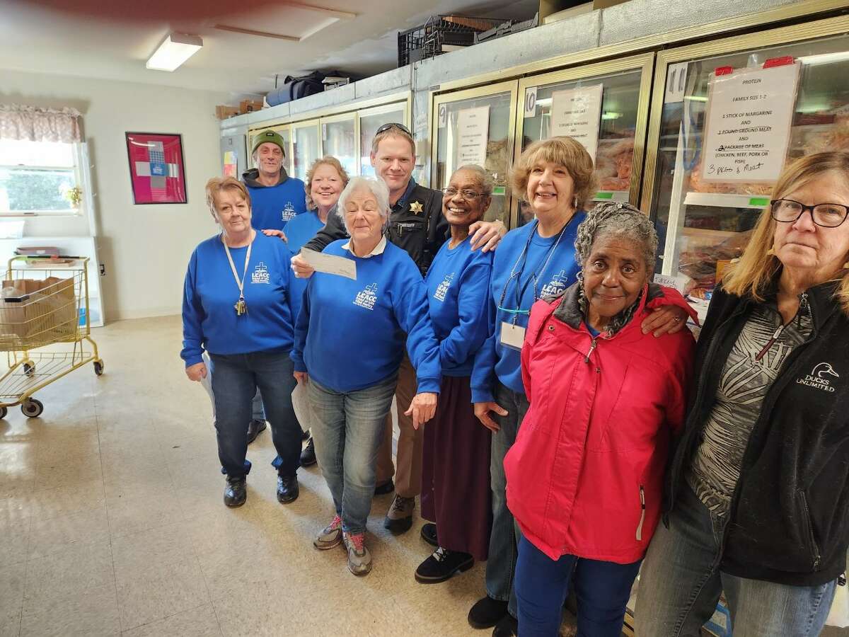 Volunteers from the Bread of Life Pantry in Baldwin accept a donation check of $500 from the Lake County Sheriff's Office Charitable Campaign.