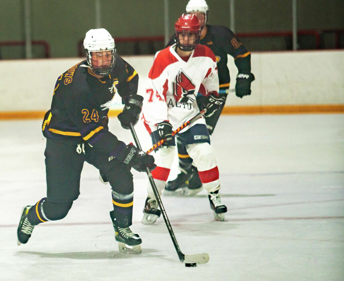Bethalto's Brock Barrows, left, scored a pair of third-period goals Monday night and helped the Eagles to a 5-4 win over Highland at the East Alton Ice Arena.
