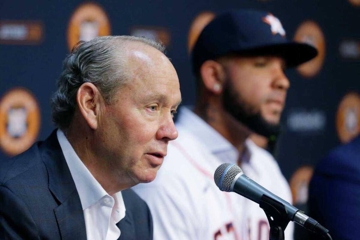 Astros owner Jim Crane, left, speaking during Tuesday's news conference to introduce new first baseman José Abreu, said not to expect a general manager hire until January.