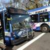 A CT Transit bus, left, waits for passengers at the corner of Temple and Elm Street in New Haven on November 29, 2022.