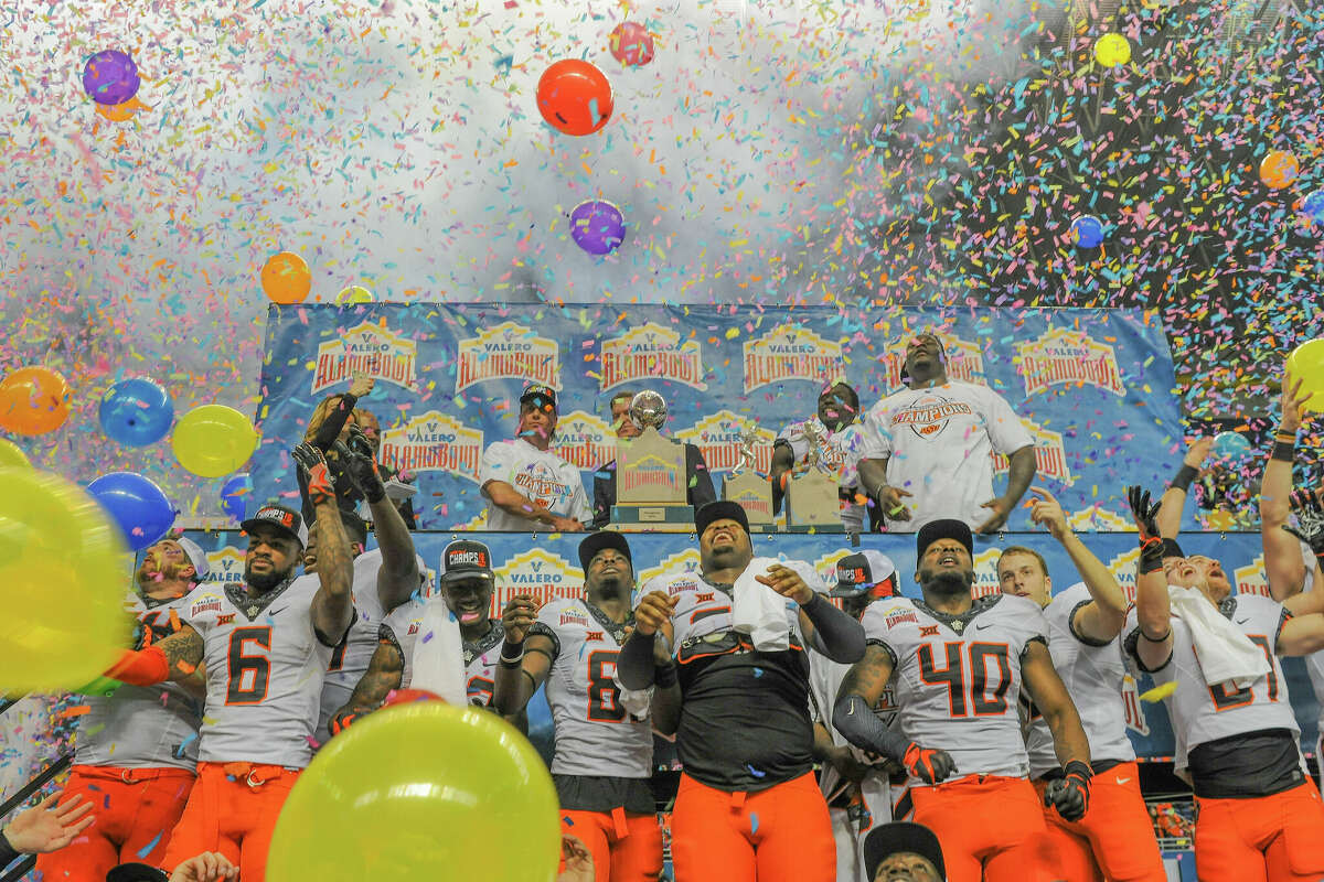 Oklahoma State players celebrate their Alamo Bowl victory against Colorado after the game between the Oklahoma State Cowboys and the Colorado Buffaloes at the Alamodome December 29, 2016 in San Antonio, Texas. 
