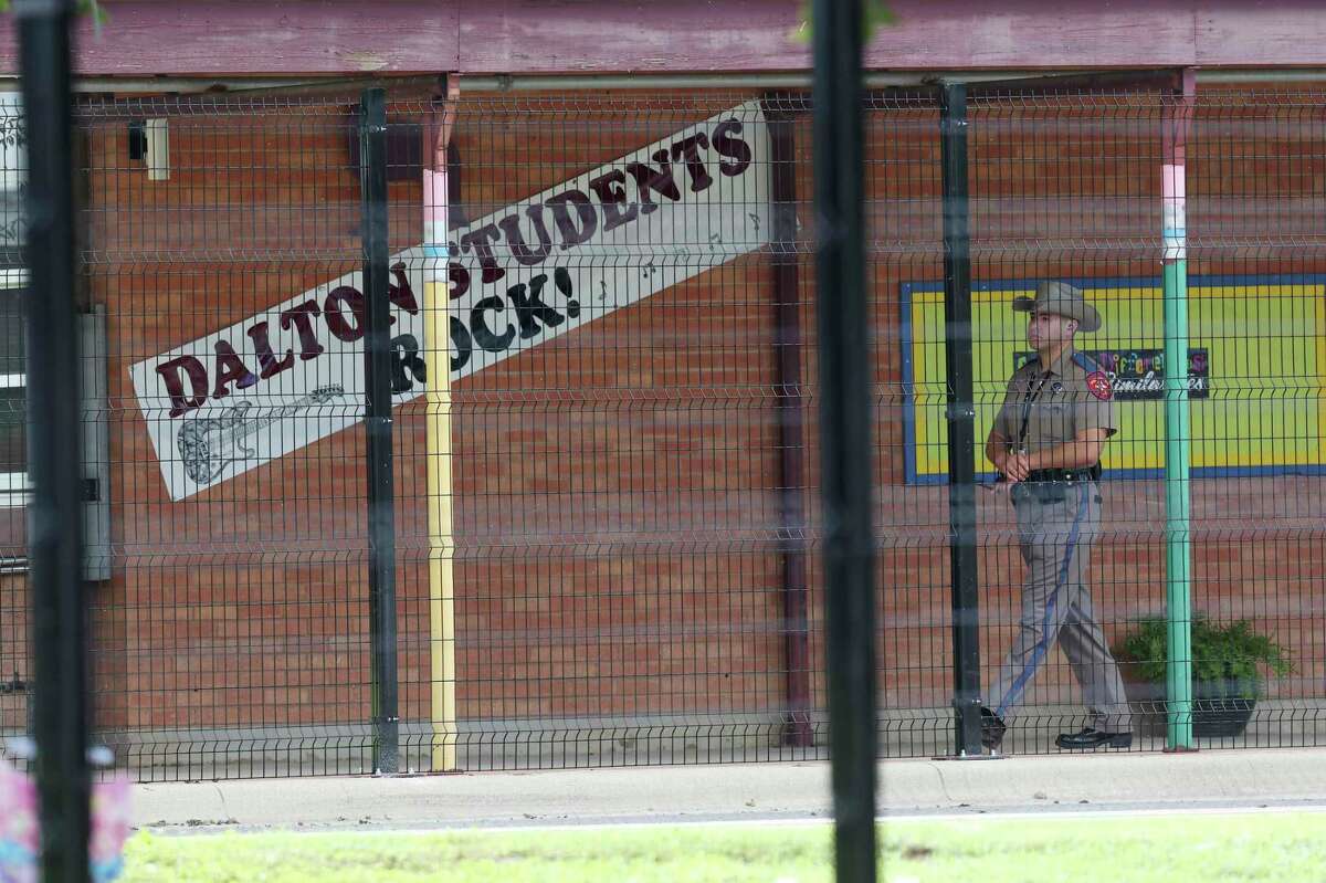A Texas Department of Public Safety trooper patrols the grounds of Dalton Elementary School in Uvalde on Sept. 6, the first day of classes.