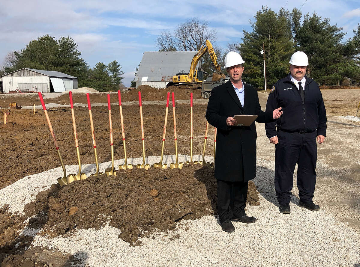 Mayor Art Risavy, left, delivers his remarks Tuesday alongside Fire Chief James Whiteford at the site of the new East Fire Station. 