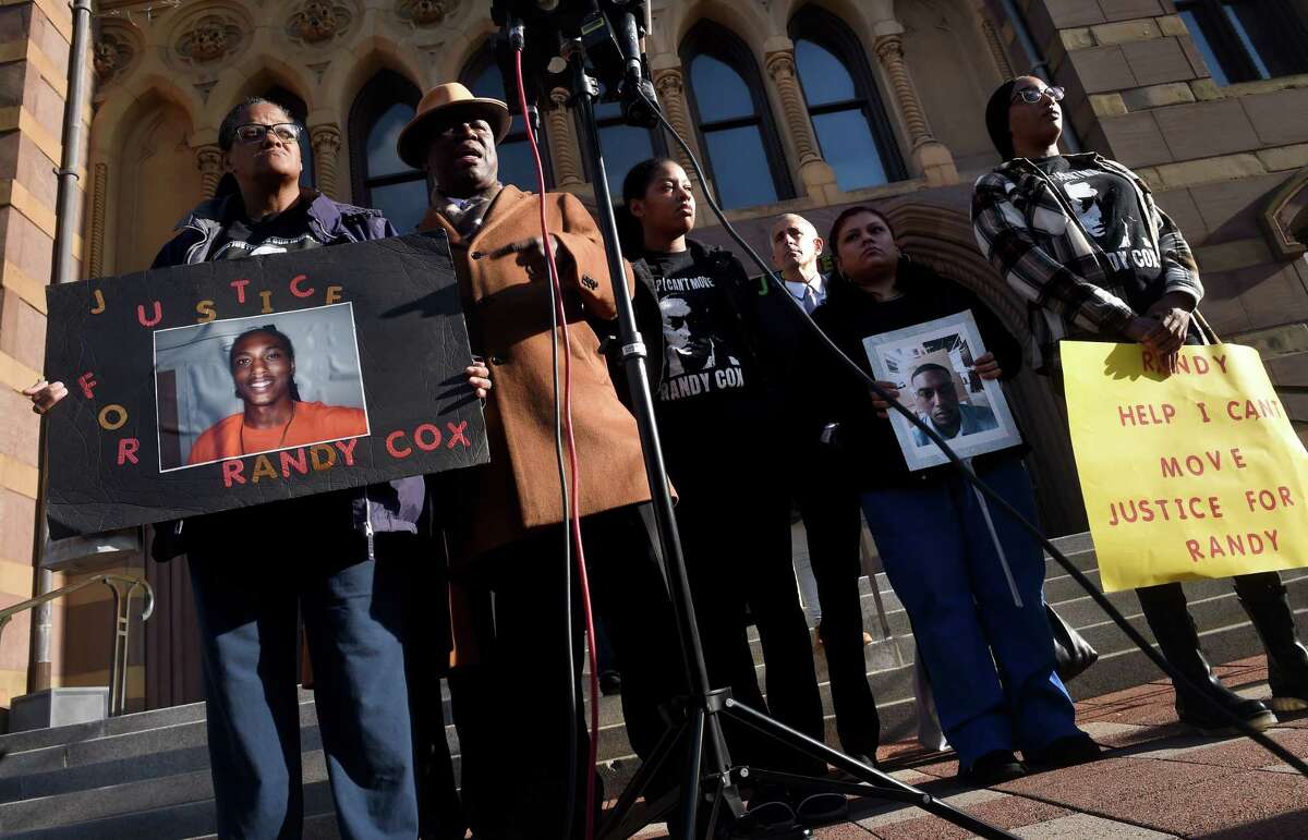 Attorney Benjamin Crump, second from left, speaks at a news conference in front of City Hall in New Haven on November 29, 2022 following the arrest of five New Haven Police officers in connection with injuries sustained by Richard "Randy" Cox while in police custody alongside Cox's mother, Doreen Coleman, far left, and sisters LaToya Boomer, center, and LaQuavius LeGrant, far right.