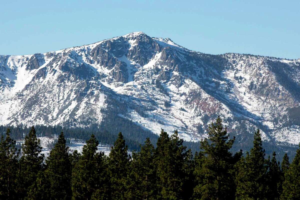 Snow dusts the mountains surrounding South Lake Tahoe, Calif. in 2020. A winter storm this week is expected to bring heavy snow to the greater Lake Tahoe area and the potential for backcountry avalanche activity.