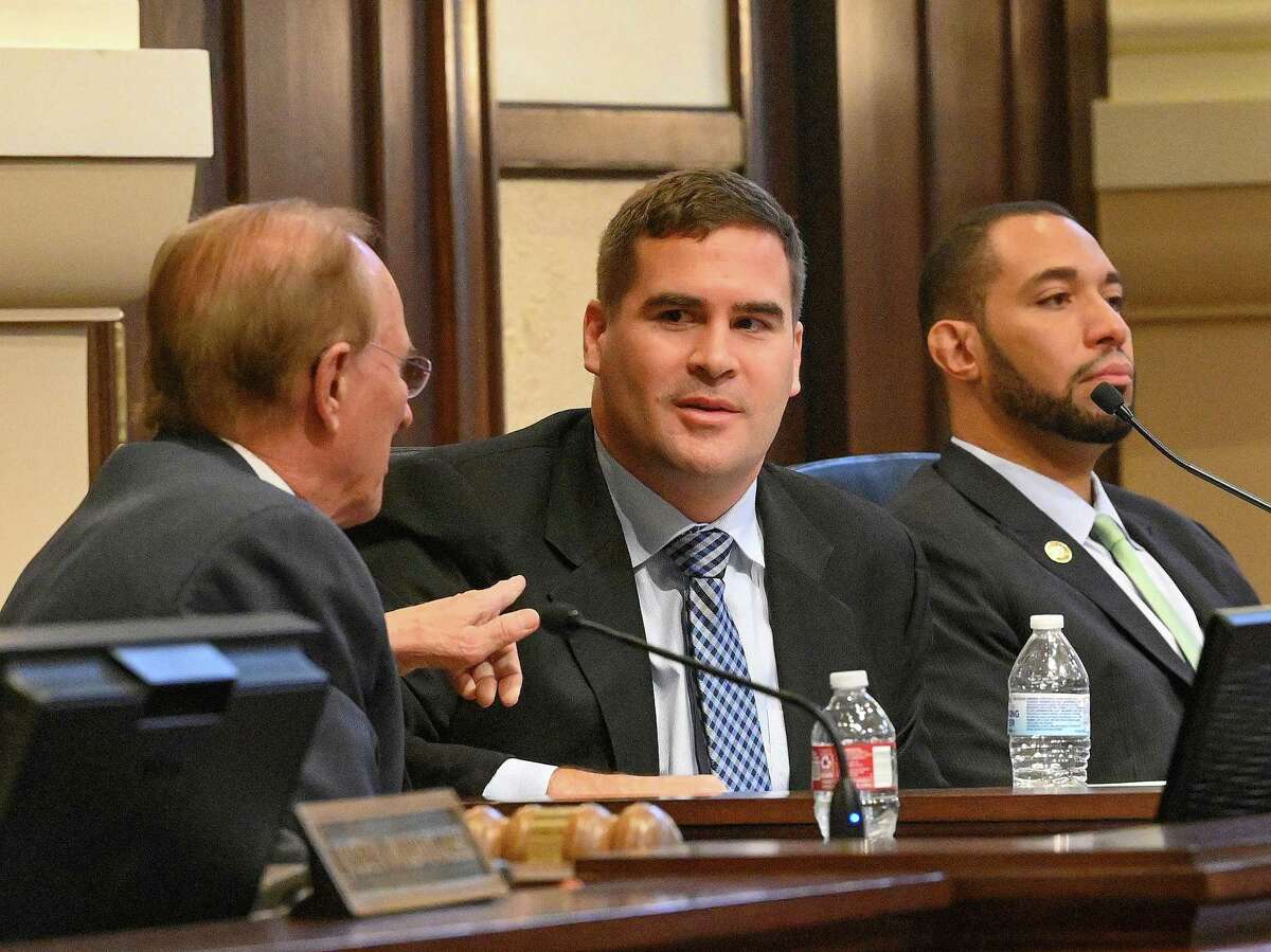 New Bexar County Commissioner Grant Moody, middle, discusses the long-awaited jail evaluation conducted by American Correctional Consultants with County Judge Nelson Wolff, left, and County Commissioner Tommy Calvert, right, during a meeting at the Bexar County Courthouse on Tuesday.