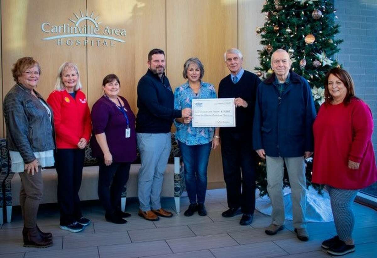 Rhonda Caveny-Jones (from left), Julie Boente, Sarah Beck, Carlinville Area Hospital & Clinics CEO Brian Burnside, Cheryl Davis, Dennis Pickerel, Rich Minster and hospital auxiliary President Patty Bouillon celebrate the auxiliary’s $75,000 contribution to the hospital.