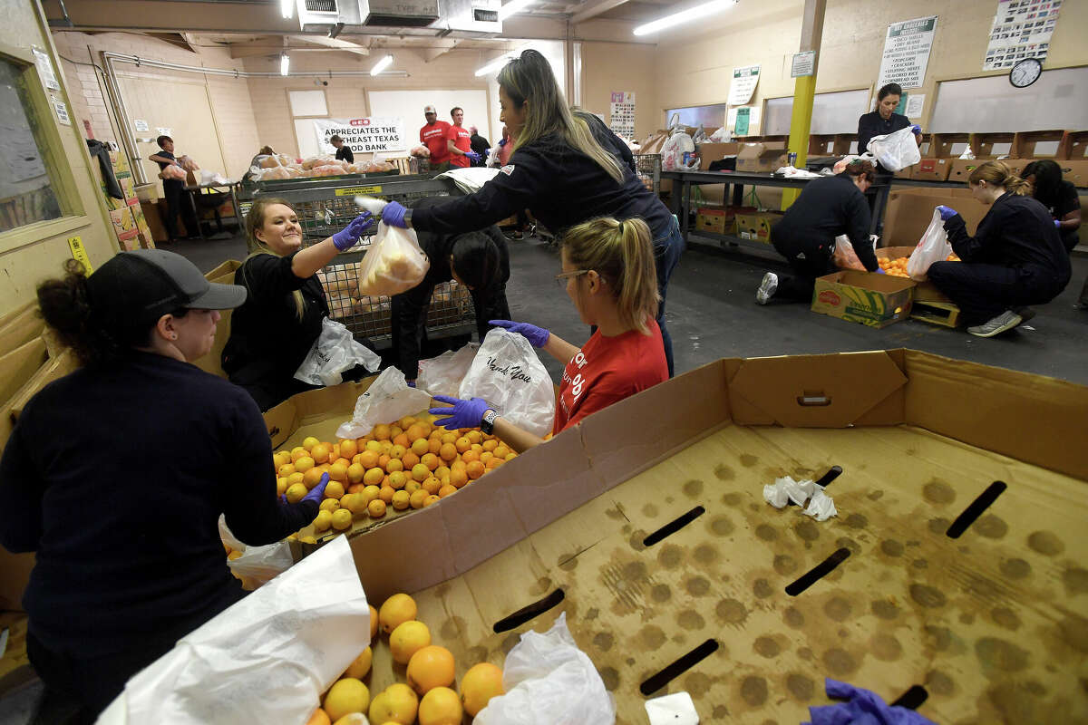 ExxonMobil sent nearly two dozen volunteers to help pack items for Saturday's holiday food distribution at the Southeast Texas Food Bank on Giving Tuesday. Photo made Tuesday, November 29, 2022 Kim Brent/Beaumont Enterprise