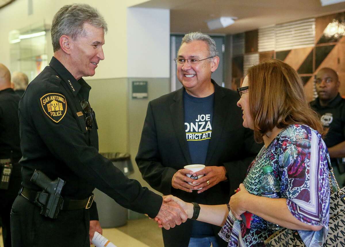 San Antonio Police Chief William McManus shakes hands with Laura Barberena, a Democratic political consultant. Barberena believes the Democratic Party is failing to connect with Latino voters.