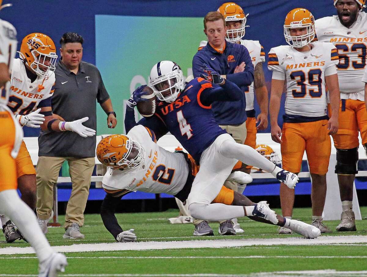SAN ANTONIO, TX - NOVEMBER 26: Wide receiver Zachari Franklin #4 of the UTSA Roadrunners is brought down by Kobe Hylton #2 of the UTEP Miners after a reception in the first half at Alamodome on November 26, 2022 in San Antonio, Texas. (Photo by Ronald Cortes/Getty Images)