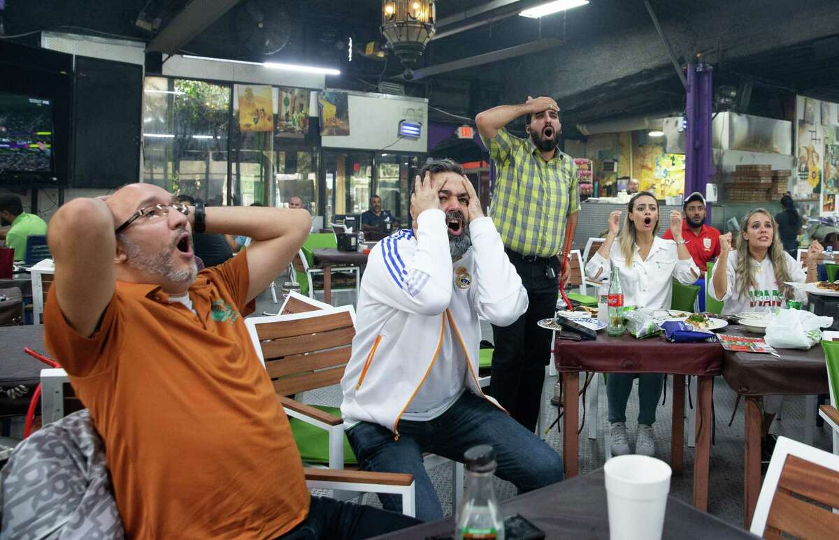 Iranian soccer fans react to their team while watching the broadcast of the U.S.-Iran World Cup match on Tuesday, Nov. 29, 2022, at Ranosh Cafe in Houston. Iran lost to the U.S. and was eliminated from the tournament.