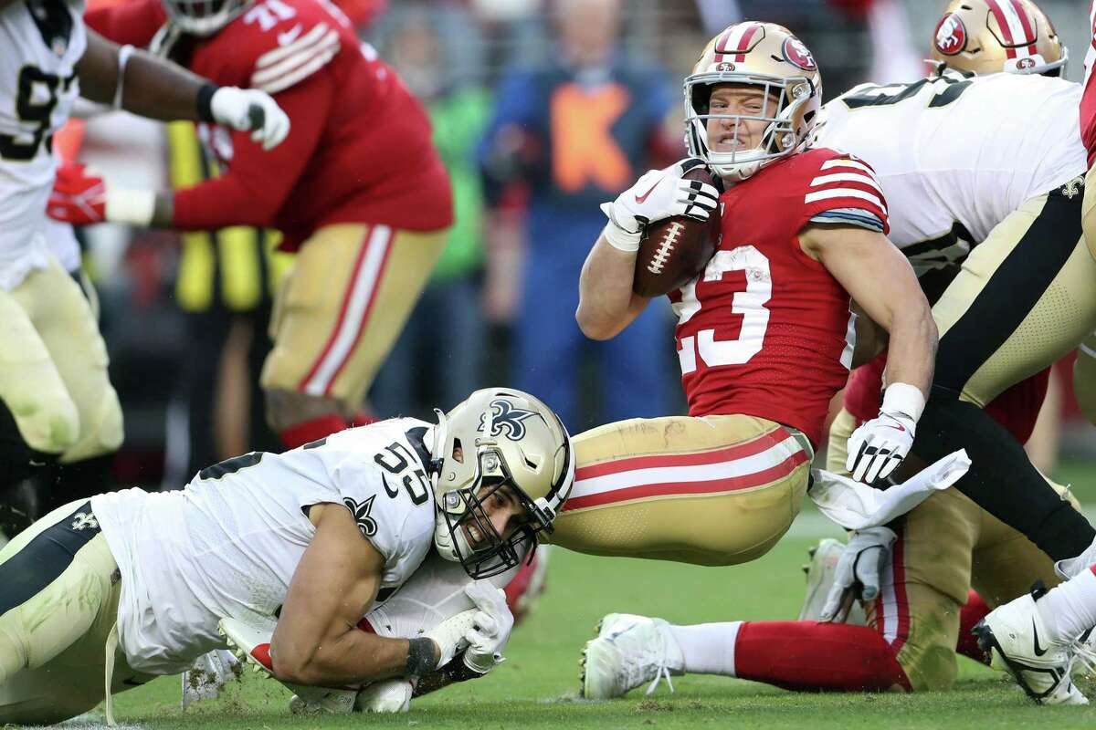 San Francisco 49ers’ Christian McCaffrey is tackled by New Orleans Saints’ Kaden Eliss in 4th quarter during Niners’ 13-0 win in NFL game at Levi’s Stadium in Santa Clara, Calif., on Sunday, November 27, 2022.