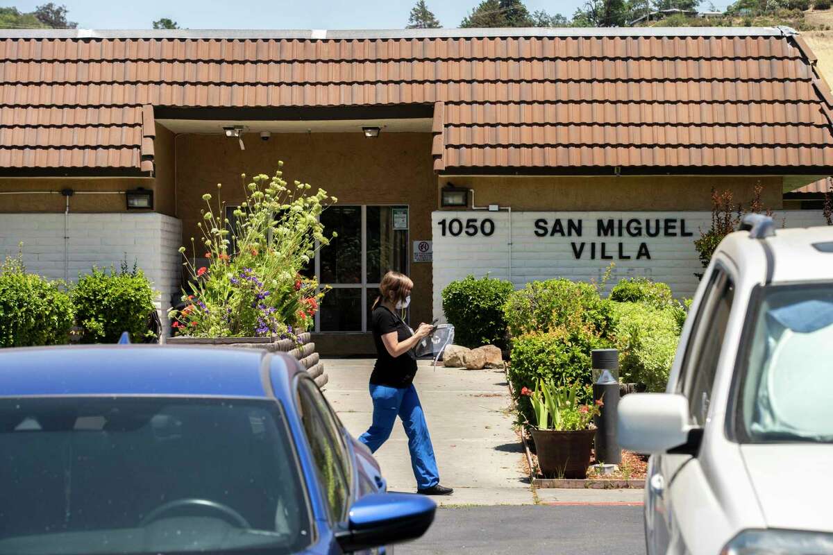 A person walks outside the San Miguel Villa nursing home on June 23, 2020, in Concord, Calif.