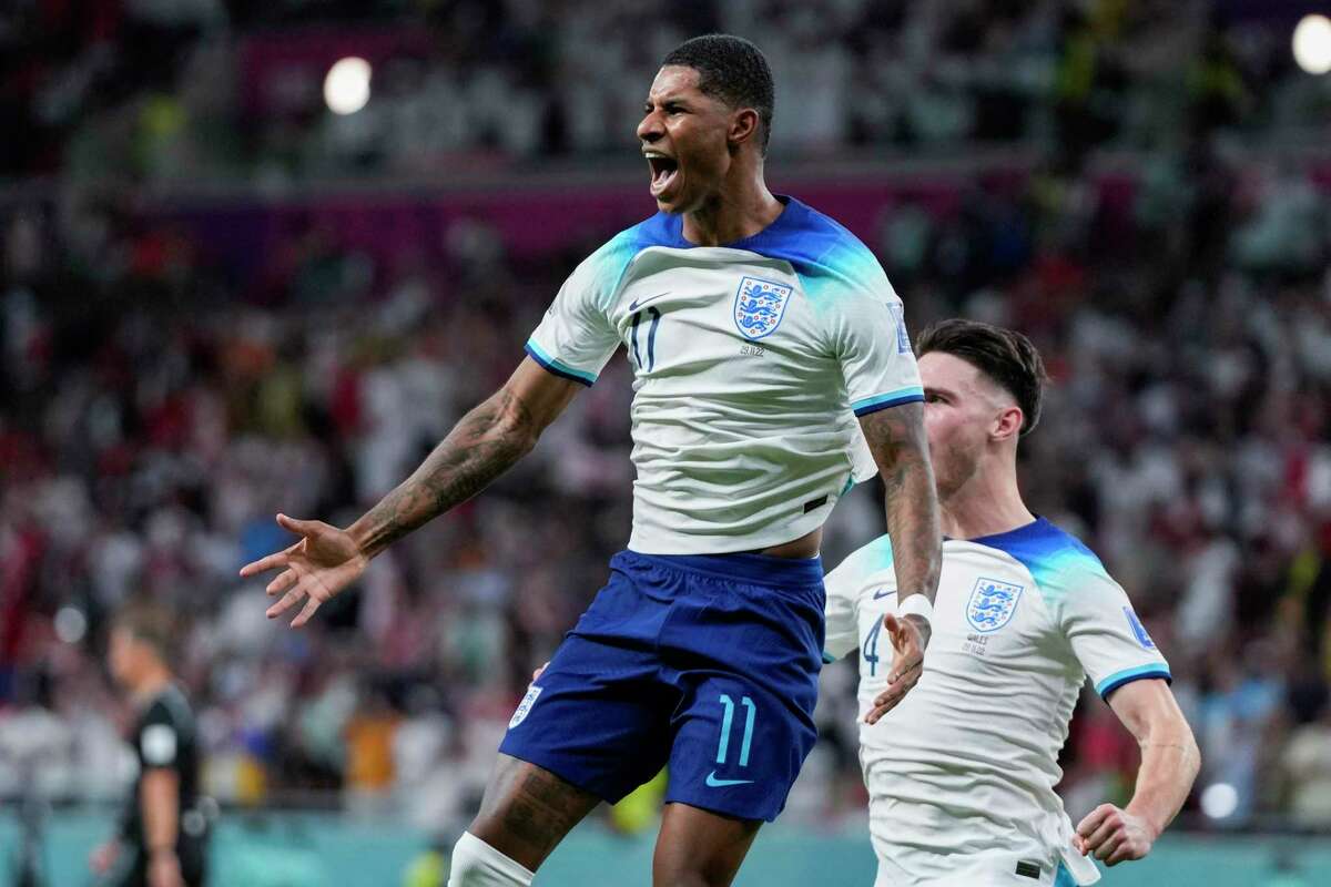 England’s Marcus Rashford celebrates after scoring the opening goal against Wales during a Group B match Tuesday.