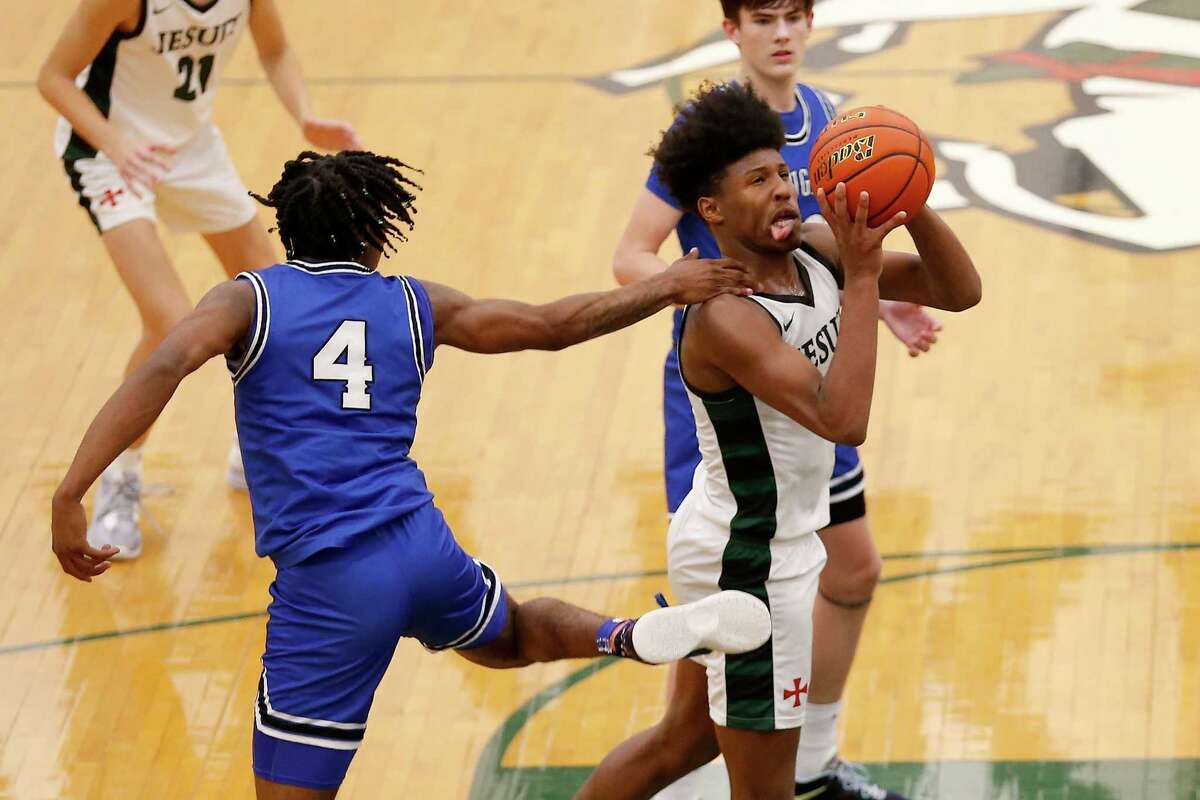 Strake Jesuit Crusaders' Jace Posey (2) is fouled by Cypress Creek Cougars Corey Hadnot (4) during the high school basketball game between the Cypress Creek Cougars and the Strake Jesuit Crusaders in Houston, TX on Tuesday, November 29, 2022. Strake defeated Cy Creek 67-65.