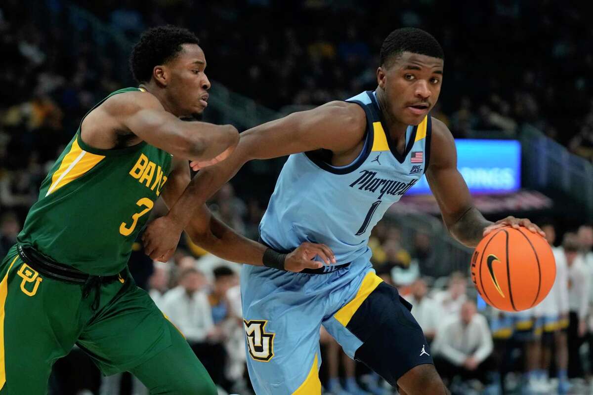 Marquette's Kam Jones drives past Baylor's Dale Bonner during the first half of an NCAA basketball game Tuesday, Nov. 29, 2022, in Milwaukee.