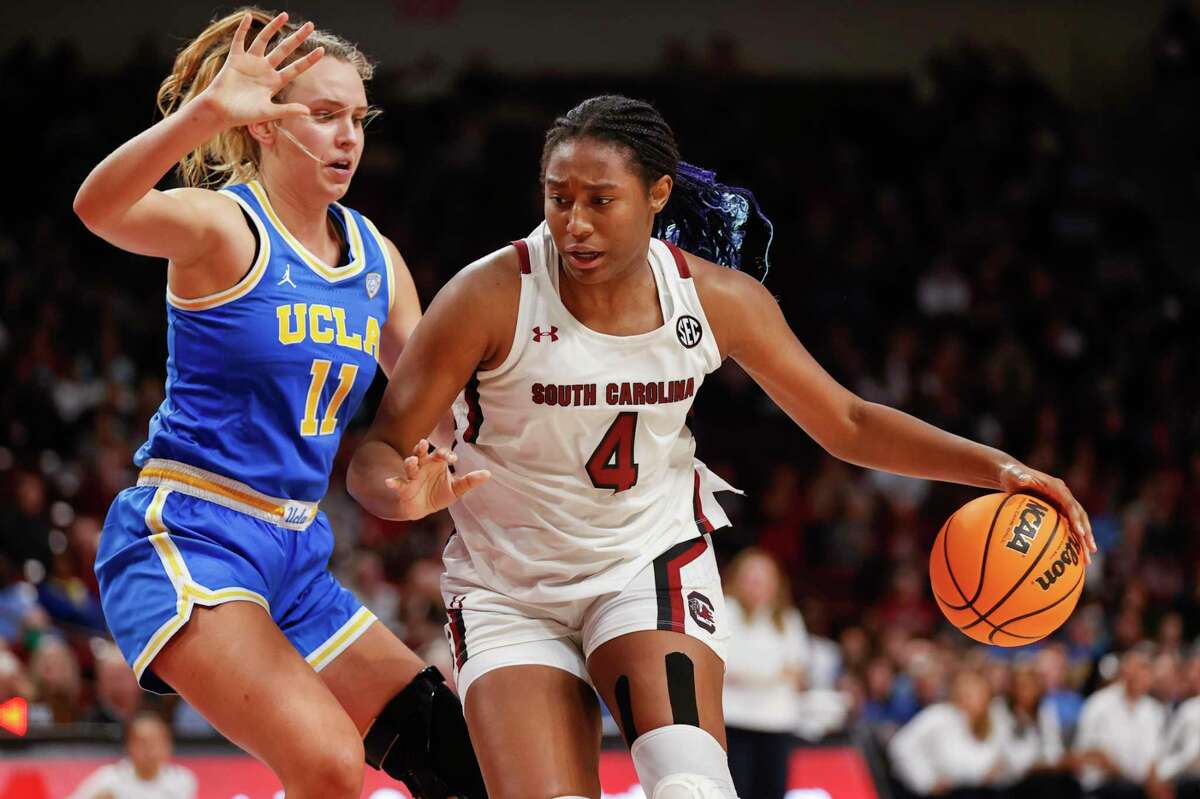 South Carolina forward Aliyah Boston, right, drives into UCLA forward Emily Bessoir during the second half of an NCAA college basketball game in Columbia, S.C., Tuesday, Nov. 29, 2022. South Carolina won 73-64. (AP Photo/Nell Redmond)