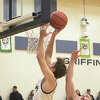 Father McGivney's Jacob Huber rises for a layup against New Athens on Tuesday. Huber finished with seven points. 