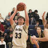 Father McGivney's Gabe Smith attempts a putback layup against New Athens on Tuesday. 