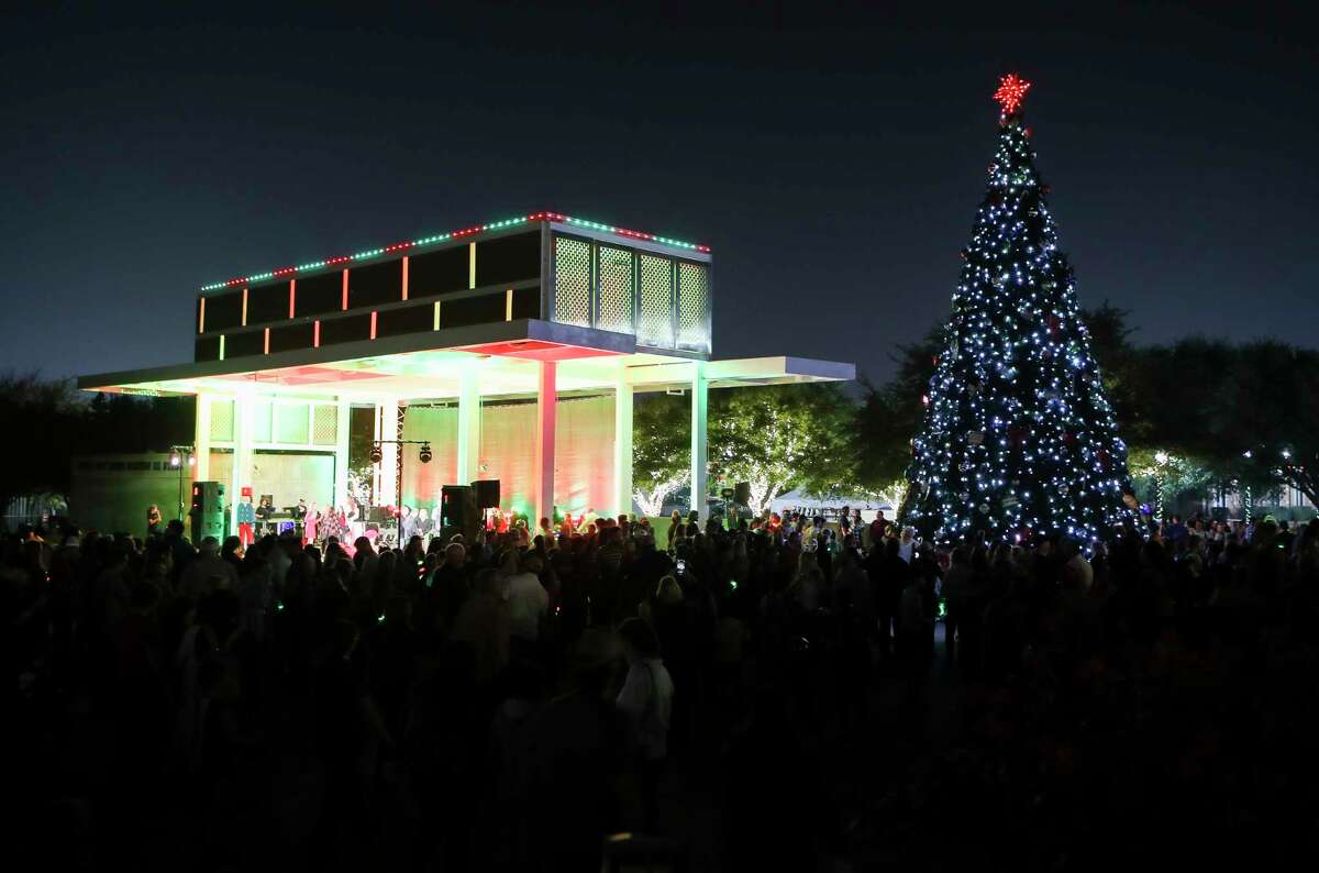 People gather for Conroe’s Christmas tree lighting celebration at Heritage Place Park, Tuesday, Nov. 29, 2022. Aside from Conroe's official Christmas tree, the park is decorated in white lights for the season. 