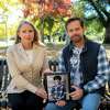 Laura and Chris Didier, the parents of Zach Didier, who died at age 17 after taking a fake prescription pill that contained fentanyl, hold one of his senior photographs at a bench installed in his honor in Sacramento on Nov. 13. "It should never have happened with Zach and it should never happen again. No one should be suffering like this," Chris said.