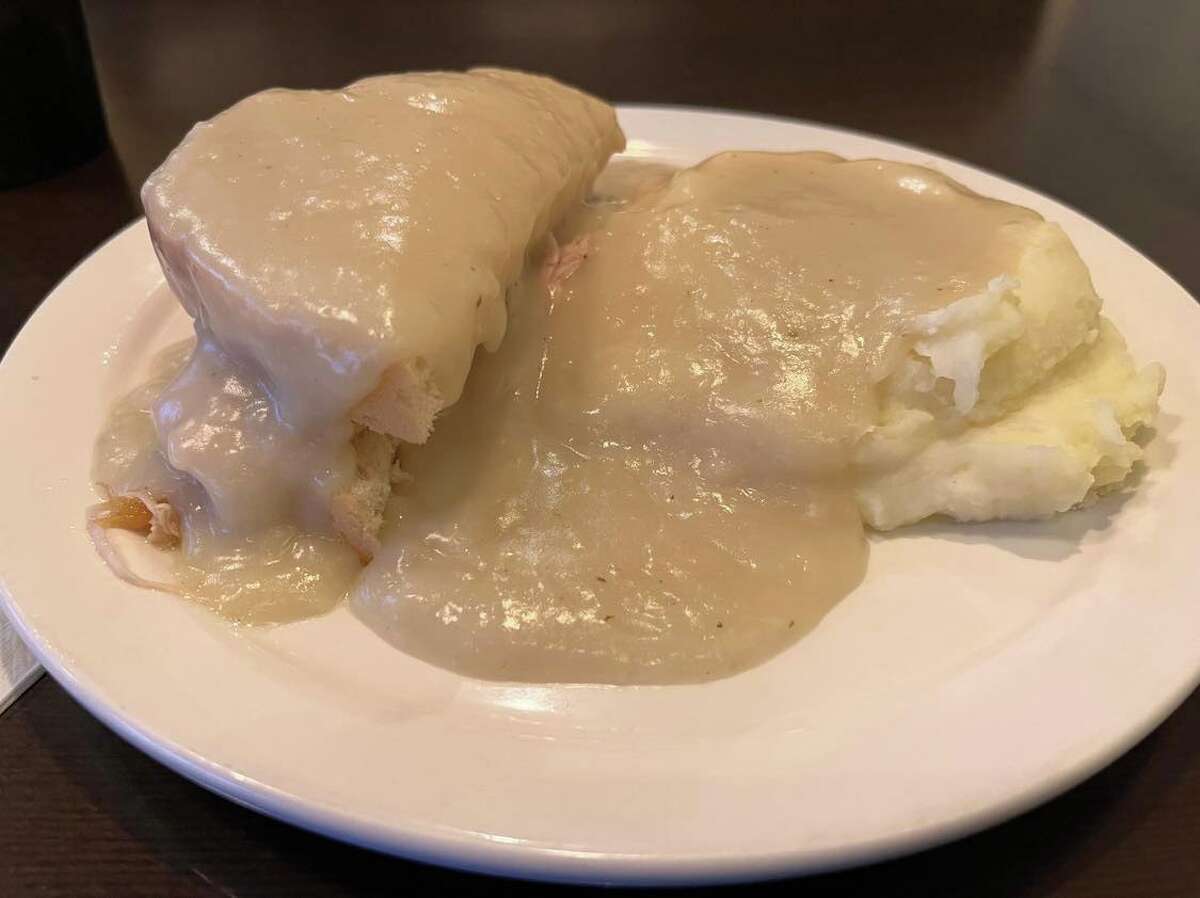 The hot turkey sandwich at Alex's Railside Restaurant includes pulled turkey snuggled between two slices of thick white bread, cushioned by a generous portion of mashed potatoes and covered in a blanket of gravy. 