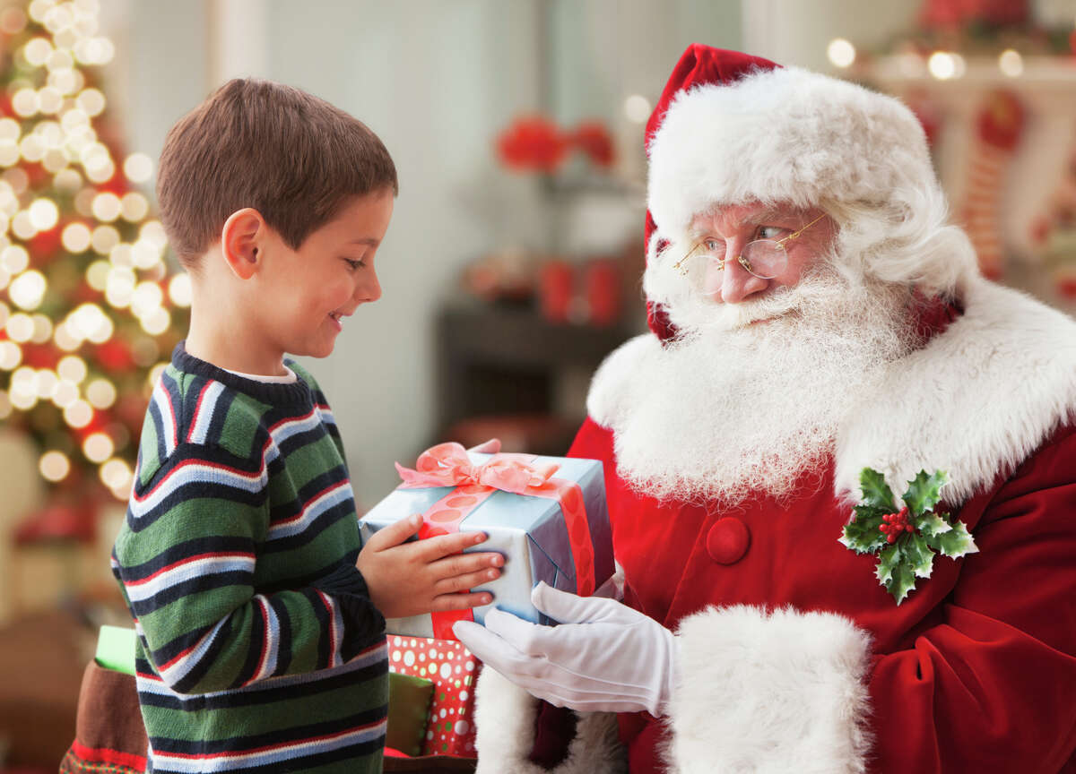 Santa giving a boy a Christmas present