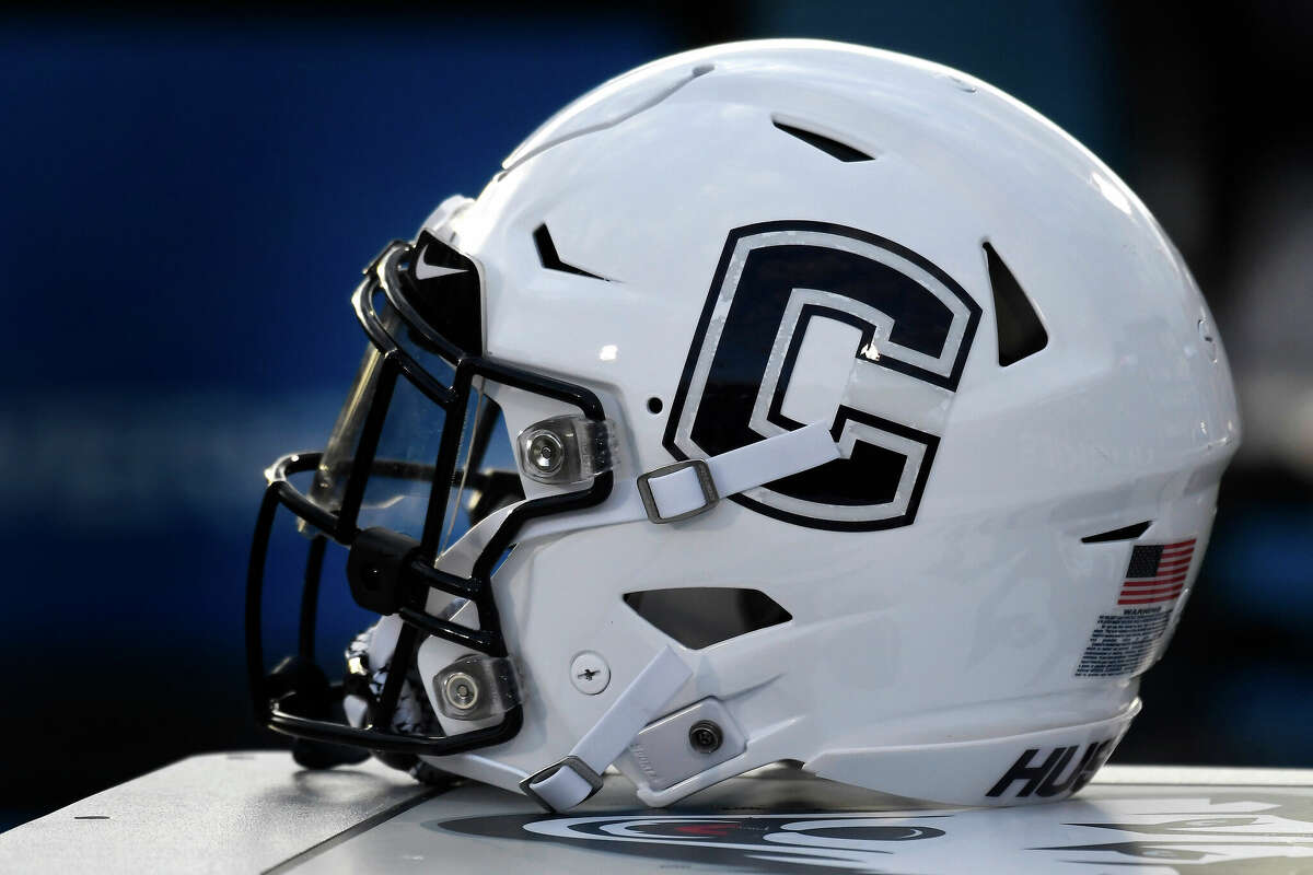 In this Sept. 7, 2019, file photo, Connecticut football helmet rests on the sideline during an NCAA college football game in East Hartford. 