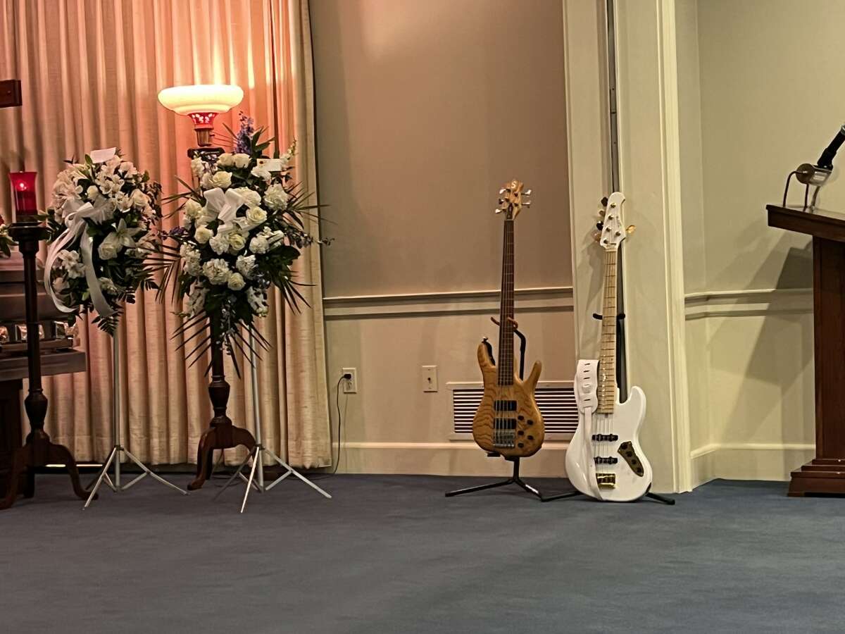 Two of Michael Batts' basses in the chapel at his wake and funeral.