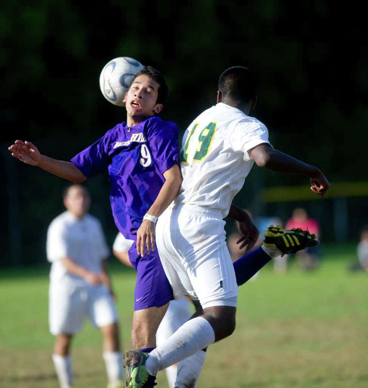 Westhill's Christian Esquivel and Trinity Catholic's Andre Gittens collide as Trinity Catholic hosts Westhill High School in a boys soccer game Monday, October 11, 2010.