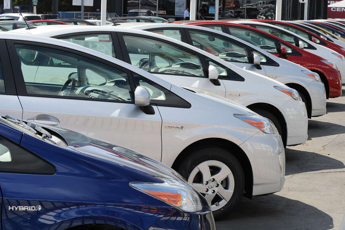 Toyota Prius hybrid model cars wait for customers at a Toyota dealership in California.