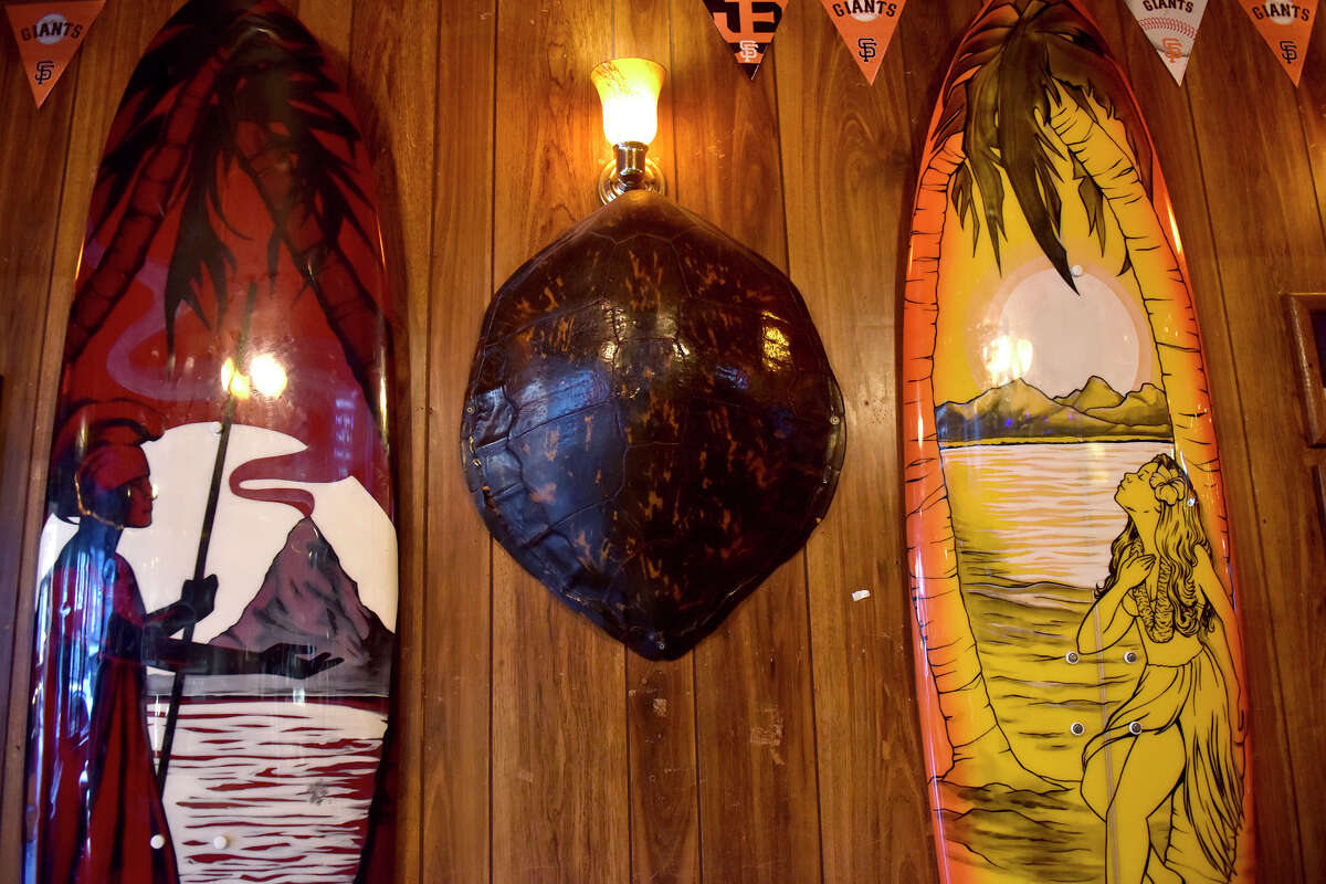 Surfboards and a giant turtle shell are just some of the many colorful decorations on the wall inside Mauna Loa, in San Francisco's Marina District. 