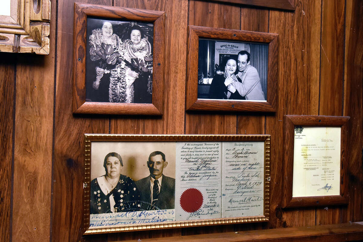 Family photos tied to the Hawaiian origins of Mona Lua line the walls near the pool table inside the bar.