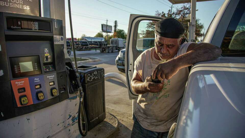 Clinton Park local, Willie, pumps gas as prices drop in some gas stations on Wednesday, Nov. 30, 2022, at Premium State Oil in Houston. Willie shares 