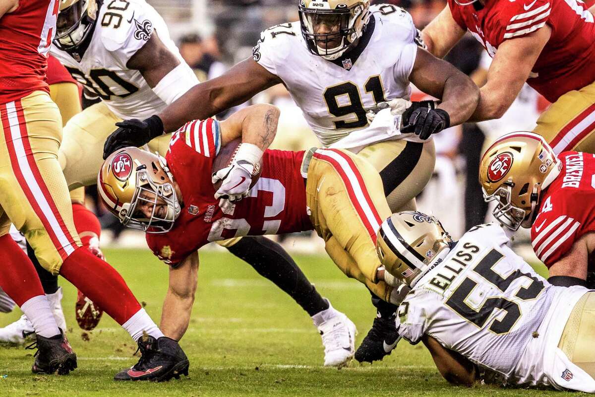 San Francisco 49ers running back Christian McCaffrey (23) falls as he is being tackled by New Orleans Saints linebacker Kaden Elliss (55) during the second half of a NFL football game in Santa Clara, Calif., Sunday, Nov. 27, 2022. The 49ers defeated the Saints 13-0.