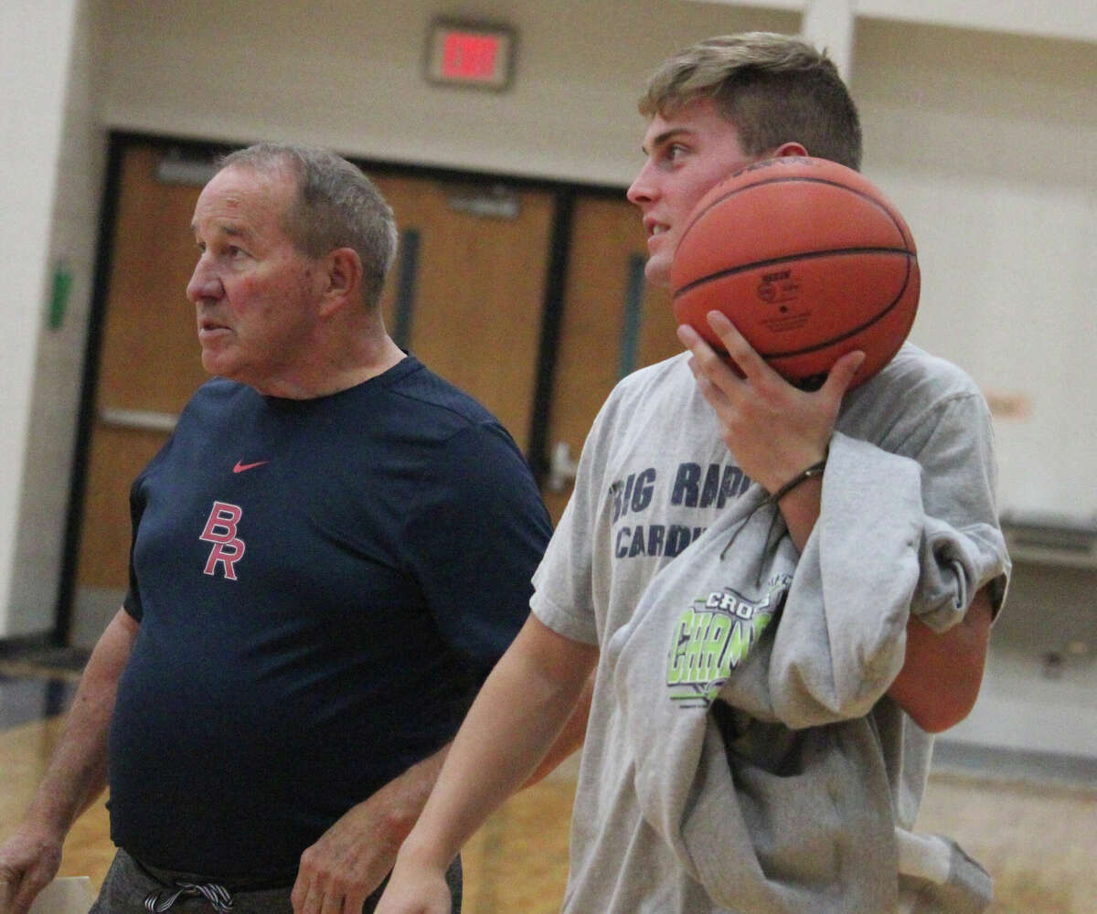 Big Rapids coach Kent Ingles (left) and senior Ben Knuth watch the action during a Cardinal practice on Wednesday.