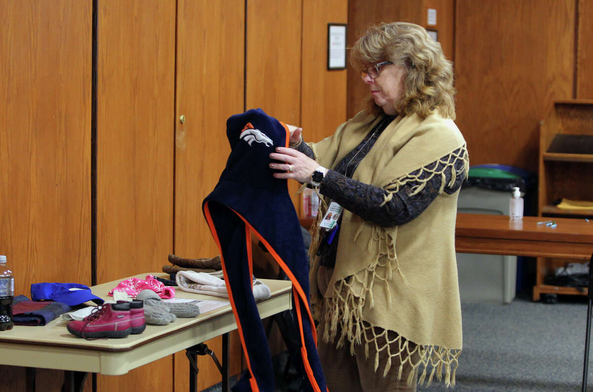 Town of Greenwich employee Patsy Schumacher tidies up a table of items during the annual distribution of new and gently used winter coats along with diapers to residents at Town Hall in Greenwich, Conn., on Wednesday November 30, 2022. The coat drive was sponsored by Board of Human Services, Greenwich Department of Human Services Fund, St. Paul's and Mothers for Others. Over 600 coats were distributed to 172 families and Mothers for Others distributed 5,050 diapers and pullups. Wipes were also distributed. For more information on GDHS services, visit https://www.greenwichct.gov/538/Human-Services or call the main number at 203-622-3800.