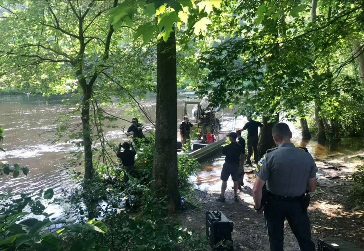 File photo shows crews searching the Farmington River in Avon for two missing swimmers on July 16, 2021. The bodies of the two boys were recovered three days later. 