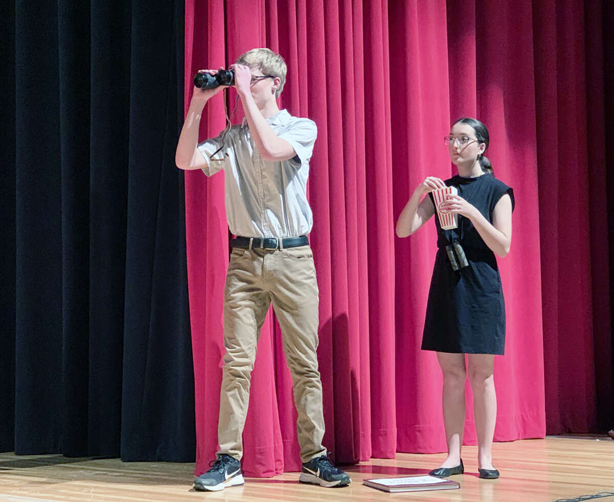 Jacksonville High School junior Collin Welch (left) and JHS senior Elliana Walden portray the characters Author and Editor, respectively, during rehearsal for the high school’s production this weekend of “The High Schooler’s Guide to the Galaxy.”