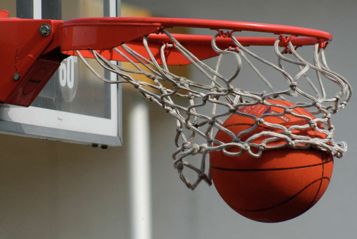 A basketball falls through a basket