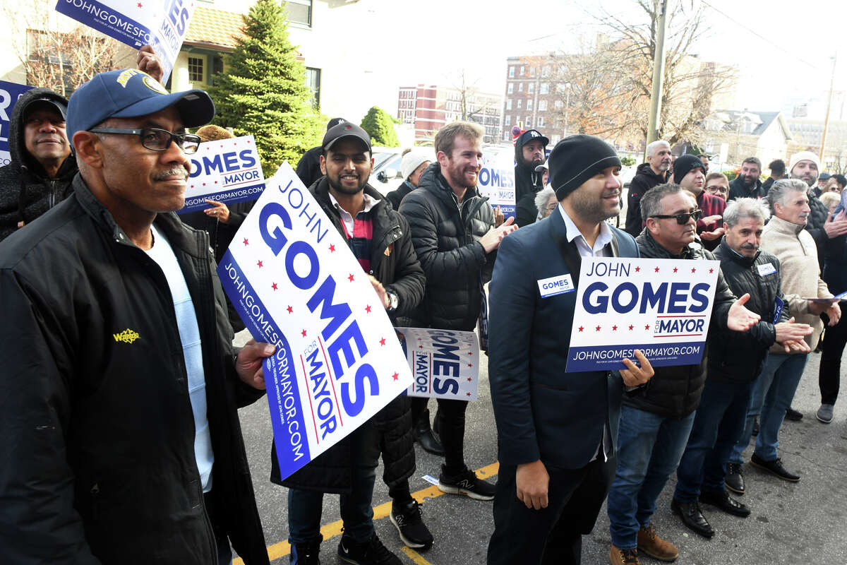 Supporters listen as John Gomes announces his candidacy for mayor in front of Bridgeport City Hall, in Bridgeport, Conn. Dec. 1, 2022.